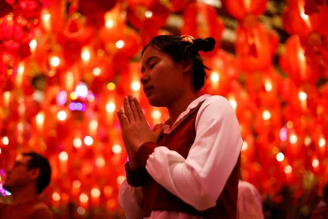 A girl prays at Wat Mangkon temple during Lunar New Year's Eve in Bangkok's Chinatown, Thailand, on February 9, 2024. (Photo by Jorge Silva/Reuters)