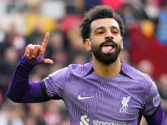 Liverpool's Mohamed Salah celebrates scoring his sides third goal during the English Premier League soccer match between Brentford and Liverpool at the Gtech Community Stadium in London, Saturday, February 17, 2024. (Photo by Kirsty Wigglesworth/AP Photo)