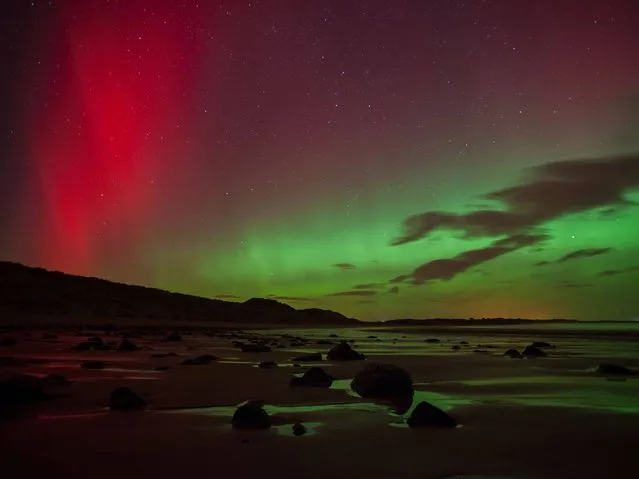 The northern lights as they are commonly known at Embleton Bay in Northumberland, on February 27, 2014. (Photo by Tom White/PA Wire)