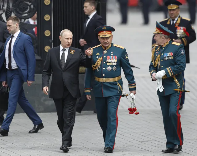 Russian President Vladimir Putin, centre left, Russian Defense Minister Sergei Shoigu, center, and Commander-in-Chief of the Graund Forces and Victory Parade Commander Colonel-General Oleg Salyukov, right, walk to attend a wreath-laying ceremony at the Tomb of the Unknown Soldier after the military parade marking 74 years since the victory in WWII in Moscow, Russia, Thursday, May 9, 2019. (Photo by Pavel Golovkin/AP Photo)