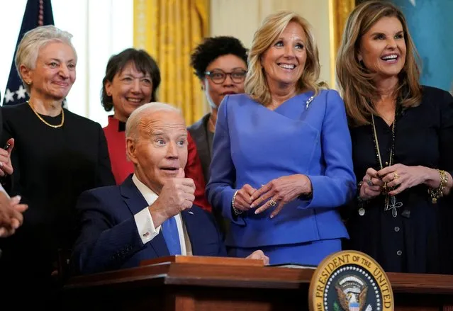 First lady Jill Biden and Maria Shriver smile as U.S. President Joe Biden gives a thumbs up after signing an executive order to expand and improve research on women's health during a Women's History Month reception at the the White House in Washington on March 19, 2024. (Photo by Kevin Lamarque/Reuters)