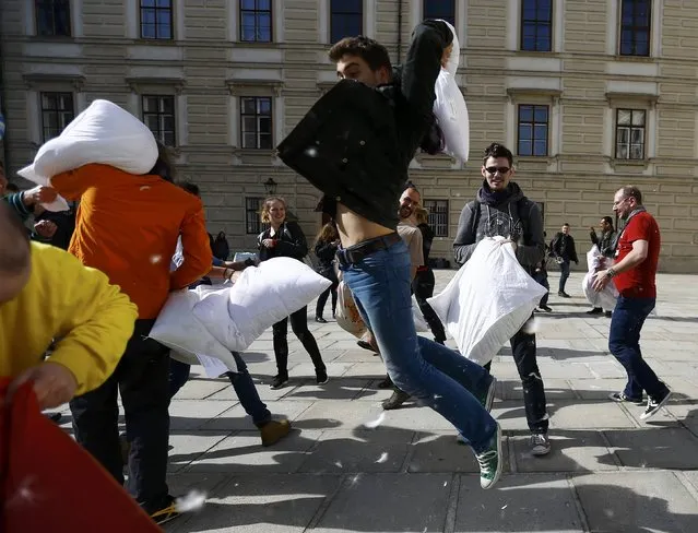 People fight with pillows during World Pillow Fight Day in Vienna, Austria, April 2, 2016. (Photo by Leonhard Foeger/Reuters)