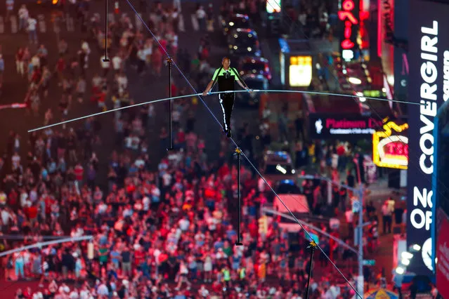 Aerialist Nik Wallenda walks the highwire with his sister Lijana (unseen) over Times Square in New York, U.S., June 23, 2019. (Photo by Eduardo Munoz/Reuters)