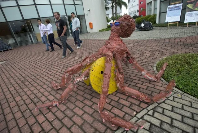 A sculpture made of trash collected in Guanabara Bay stands on display at the Rio de Janeiro Federal University as part of an exhibit titled "The Sea Isn't Made for Fish" in Rio de Janeiro, Brazil, Monday, June 1, 2015. Around 30 art students used plastic bottles, tires, old flip flops, plastic helmets, scratched CDs, old tubes and plastic supermarket bags to make sculptures of ocean fauna including an octopus and dolphins. (AP Photo/Silvia Izquierdo)