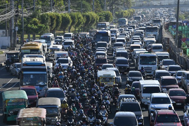 Motorcycles along with other vehicles manoeuver through a heavy traffic along a road in Manila on April 5, 2024. (Photo by Ted Aljibe/AFP Photo)