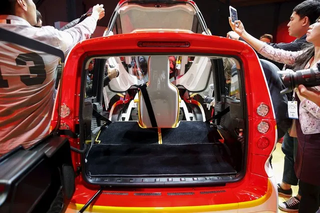 People take pictures of a high-efficiency petrol-burning concept car as it is unveiled by Royal Dutch Shell during a ceremony in Beijing, China April 22, 2016. (Photo by Damir Sagolj/Reuters)