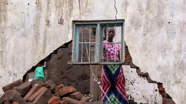 A woman looks on at her house destroyed by tropical storm Ana at Kanjedza village, in Chikwawa district, southern Malawi, January 26, 2022. (Photo by Eldson Chagara/Reuters)