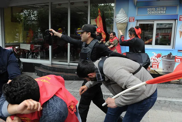 Police officers detain demonstrators, in Istanbul, Turkey, Sunday, May 1, 2016. (Photo by Omer Kuscu/AP Photo)