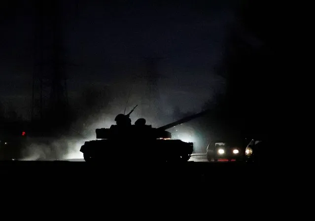 A tank drives along a street after Russian President Vladimir Putin ordered the deployment of Russian troops to two breakaway regions in eastern Ukraine following the recognition of their independence, in the separatist-controlled city of Donetsk, Ukraine on February 22, 2022. (Photo by Alexander Ermochenko/Reuters)