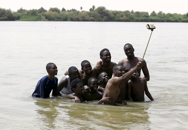 A group of young men use a selfie stick to take a picture of themselves in shallow waters known as the first cataract of the River Nile outside Khartoum, Sudan, May 22, 2015. In Sudan, which faces insurgences in the western region of Darfur and along its border with breakaway South Sudan, as well as double-digit inflation and high unemployment, life goes on for young people in the capital Khartoum. (Photo by Mohamed Nureldin Abdallah/Reuters)