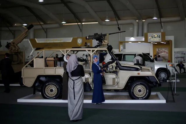 Visitors take pictures with Jordanian military vehicles during the second day of the Special Operations Forces Exhibition (SOFEX) at King Abdullah II Airbase in Amman, Jordan, May 11, 2016. (Photo by Muhammad Hamed/Reuters)