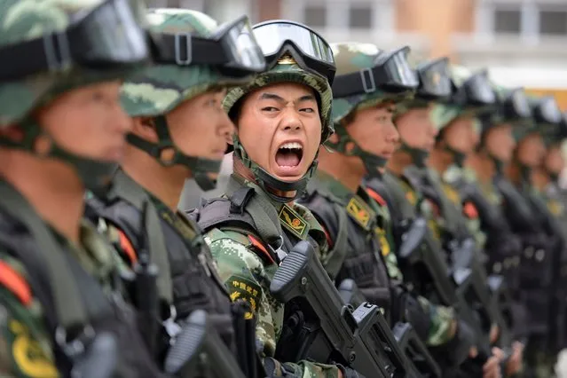 A paramilitary policeman shouts a command during a training session at a base in Taiyuan, Shanxi province, China, May 9, 2014. (Photo by Jon Woo/Reuters)