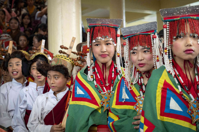 Exiled Tibetans in ceremonial outfits wait to perform a traditional dance at an event to celebrate the 89th birthday of Tibetan spiritual leader the Dalai Lama at the Tsuglakhang temple in Dharamshala, India, Saturday, July 6, 2024. (Phoot by Ashwini Bhatia/AP Photo)