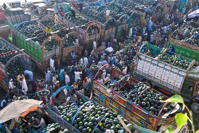 Farmers sell watermelons at the fruit market in Lahore, Pakistan on May 15, 2024. (Photo by Arif Ali/AFP Photo)