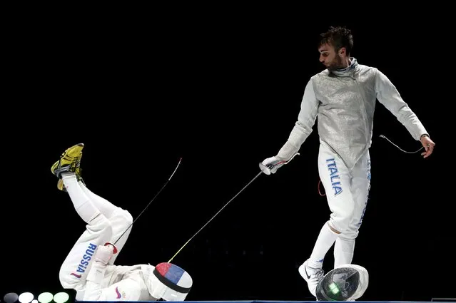 Russia's Dmitry Rigin (L) falls down as he competes against Italy's Daniele Garozzo during their men's team foil final at the World Fencing Championships in Moscow, Russia, July 19, 2015. (Photo by Grigory Dukor/Reuters)