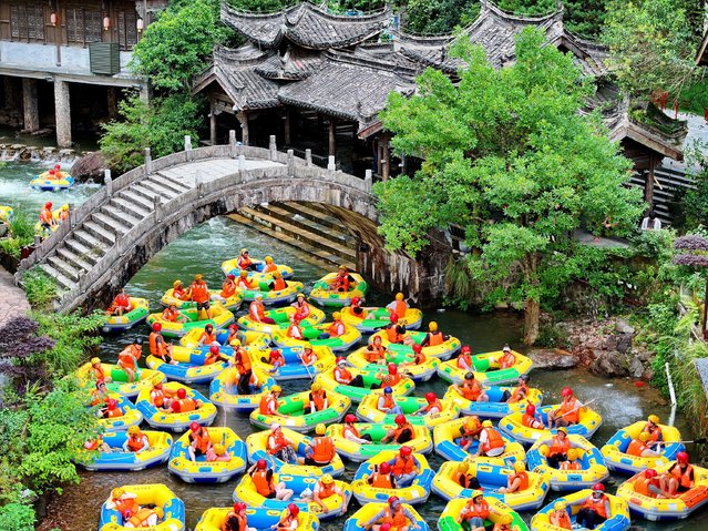 Aerial view of tourists enjoying cool rafting amid high temperatures at a scenic area on July 13, 2024 in Fuzhou, Jiangxi Province of China. (Photo by Zhu Haipeng/VCG via Getty Images)