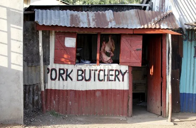 Pork is displayed in the window of a butcher's shop at the trading centre in the village of Kogelo, west of Kenya's capital Nairobi, July 15, 2015. (Photo by Thomas Mukoya/Reuters)