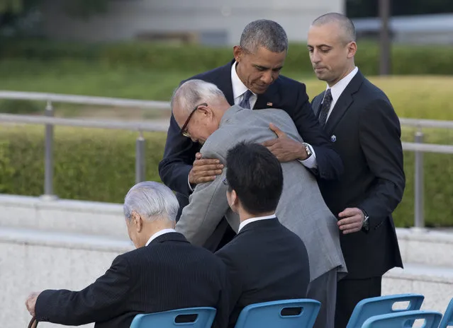 U.S. President Barack Obama hugs Shigeaki Mori, an atomic bomb survivor; creator of the memorial for American WWII POWs killed at Hiroshima, during a ceremony at Hiroshima Peace Memorial Park in Hiroshima, western Japan, Friday, May 27, 2016. Obama on Friday became the first sitting U.S. president to visit the site of the world's first atomic bomb attack, bringing global attention both to survivors and to his unfulfilled vision of a world without nuclear weapons. (Photo by Carolyn Kaster/AP Photo)
