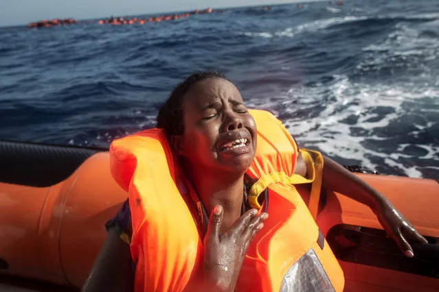 A woman cries after losing her baby in the water as she sits in a rescue boat from the Migrant Offshore Aid Station (MOAS) “Phoenix” vessel on May 24, 2017 off Lampedusa, Italy. The Migrant Offshore Aid Station (MOAS) “Phoenix” vessel rescued 603 people after one of three wooden boats partially capsized leaving more than 30 people dead. Numbers of refugees and migrants attempting the dangerous central Mediterranean crossing from Libya to Italy has risen since the same time last year with more than 43,000 people recorded so far in 2017. In an attempt to slow the flow of migrants Italy recently signed a deal with Libya, Chad and Niger outlining a plan to increase border controls and add new reception centers in the African nations, which are key transit points for migrants heading to Italy. MOAS is a Malta based NGO dedicated to providing professional search-and-rescue assistance to refugees and migrants in distress at sea. Since the start of the year MOAS have rescued and assisted 3572 people and are currently patrolling and running rescue operations in international waters off the coast of Libya. (Photo by Chris McGrath/Getty Images)