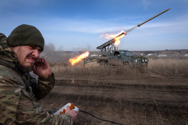 A Ukrainian officer with the 56th Separate Motorized Infantry Mariupol Brigade fires rockets from a pickup truck at Russian positions on the front line near Bakhmut in Ukraine's Donetsk region on March 5, 2024. Ukraine faces twin challenges of fighting Russia and the shifting political sands in the US. (Photo by Efrem Lukatsky/AP Photo)