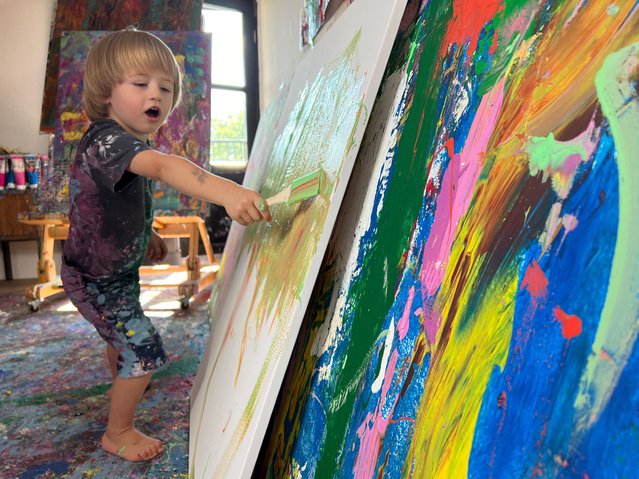 Two-year-old Laurent Schwarz works on a picture in Neubeuren, Germany on August 6, 2024. Laurent, whose works have been sold to fans in Birmingham and the Bahamas prepares for his first exhibition later this year. (Photo by Louisa Off/Reuters)