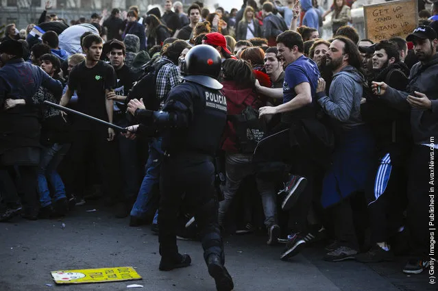Riot police clash with demonstrators during heavy clashes with demonstrators during a 24-hour strike on March 29, 2012 in Barcelona, Spain