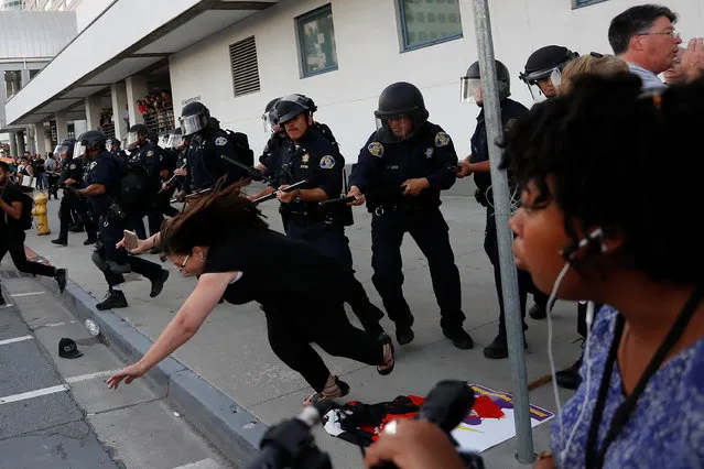 A woman falls as police officers move the line during a demonstration against Republican U.S. presidential candidate Donald Trump outside his campaign event in San Jose, California, U.S. June 2, 2016. (Photo by Stephen Lam/Reuters)