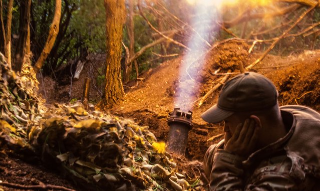 Ukrainian soldier from the 28th Artillery Battalion firing a 120mm mortar at a Russian target in the zero line in the forest near Bakhmut on May 11, 2023. The Russian and Ukrainian armies clash in the Donbass, the fighting is intense and the battle is raging. With a range of 6 km this weapon is a valuable asset to destroy enemy targets. (Photo by Jose Hernandez/Rex Features/Shutterstock)