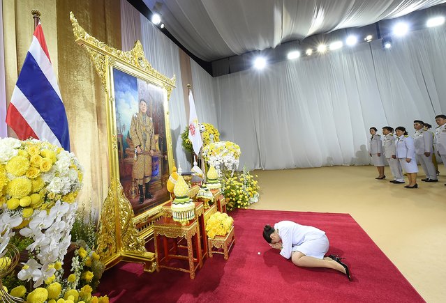 A handout photo made available by the Royal Thai Government shows Thailand's newly elected Prime Minister Paetongtarn Shinawatra (C) receiving a royal command appointment to become prime minister, in front of a portrait of the King, at the Pheu Thai Party's headquarters in Bangkok, Thailand, 18 August 2024. The ruling Pheu Thai Party leader Paetongtarn Shinawatra, the youngest daughter of the coup-ousted former premier Thaksin Shinawatra, succeeded in the parliamentary vote to become Thailand's 31st prime minister and the country's youngest prime minister in history. (Photo by The Royal Thai Government/EPA/EFE)