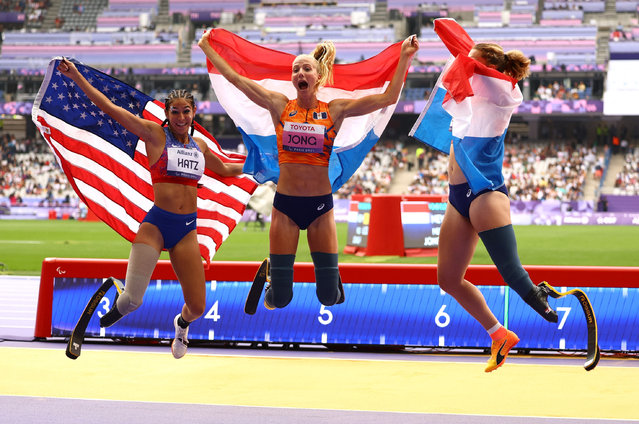 Gold medallist Fleur Jong of Netherlands leaps for joy after winning the T64 women’s long jump final, alongside fellow medallists Marlene van Gansewinkel (right) and Beatriz Hatz at the Stade de France stadium, during the 2024 Paralympics, Saturday, August 31, 2024, in Paris, France. (Photo by Ümit Bektaş/Reuters)