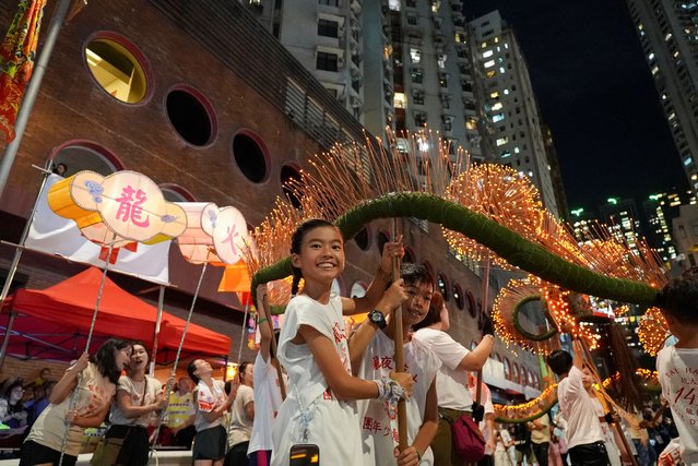 Children and young performers take part in the Tai Hang Fire Dragon Dance to celebrate the Mid-Autumn Festival in Hong Kong, China on September 16, 2024. (Photo by Joyce Zhou/Reuters)