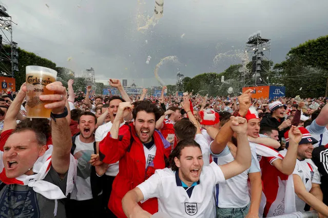England fans hold glasses of beer while reacting after their team scores goal as they watch the England v Wales EURO 2016 Group B soccer match, near the Eiffel Tower, in Paris, France, June 16, 2016. (Photo by Philippe Wojazer/Reuters)