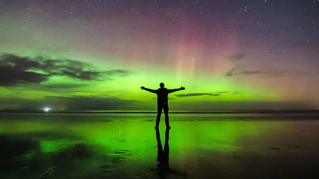 A visitor to Findhorn Beach, on the Moray coast in the Highland council area of north of Scotland, at the weekend, January 8, 2022 showed that you don’t have to go to the Arctic Circle to experience the splendour of the northern lights, or aurora borealis. (Photo by Paul Scott/Triangle News)