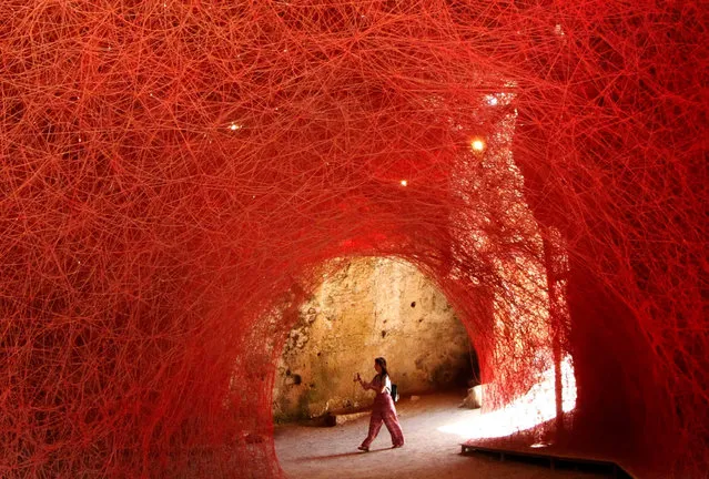 A visitor views the art installation “A Walk Through the Line” by Japanese artist Chiharu Shiota, that is on display as part of the European Capital of Culture 2017 exhibitions program, in Paphos, Cyprus, 19 July 2017. Since January 2017, the city of Pafos holds the title of the European Capital of Culture 2017, along with Aarhus in Denmark. (Photo by Katia Christodoulou/EPA)