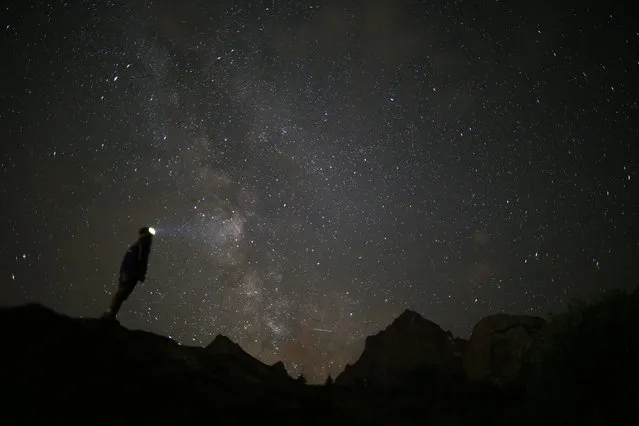 A photographer prepares to take pictures of the annual Perseid meteor shower in the village of Crissolo, near Cuneo, in the Monviso Alps region of northern Italy, on August 13, 2015. The Perseid meteor shower occurs every year when the Earth passes through the cloud of debris left by Comet Swift-Tuttle. (Photo by Marco Bertorello/AFP Photo)