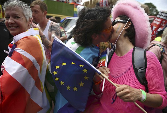 People kiss as holding a European Union flag as they take part in the annual Pride London Parade, which highlights issues of the gay, lesbian and transgender community, in London, Britain June 25, 2016. (Photo by Neil Hall/Reuters)