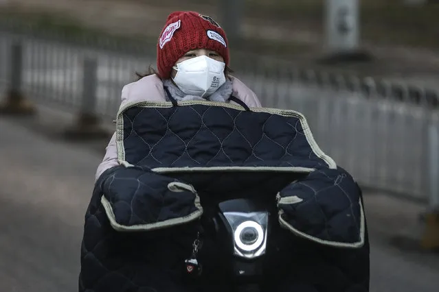 A woman wears a protective mask as she rides on a bicycle on February 3, 2020 in Wuhan, Hubei province, China. The number of those who have died from the Wuhan coronavirus, known as 2019-nCoV, in China climbed to 361 and cases have been reported in other countries including the United States, Canada, Australia, Japan, South Korea, India, the United Kingdom, Germany, France, and several others. (Photo by Getty Images/China Stringer Network)