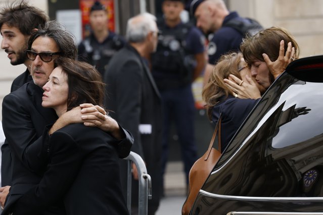 Jane Birkin's daughter Charlotte Gainsbourg, left, and her husband Yvan Attal leave while Birkin's other daughter Lou Doillon, right, embraces a person after Jane Birkin's funerals ceremony at the Saint-Roch church in Paris, Monday, July 24, 2023. Actor and singer Jane Birkin, who made France her home and charmed the country with her English grace, natural style and social activism, has died last week at age 76. (Photo by Thomas Padilla/AP Photo)