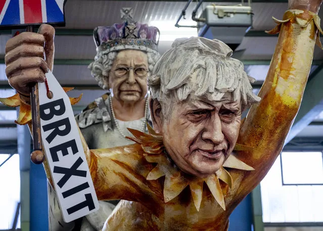 Figures depicting British Prime Minister Boris Johnson, right, and the Queen Elizabeth II are shown during a press preview for the Mainz carnival, in Mainz, Germany, Tuesday, February 18, 2020. (Photo by Michael Probst/AP Photo)