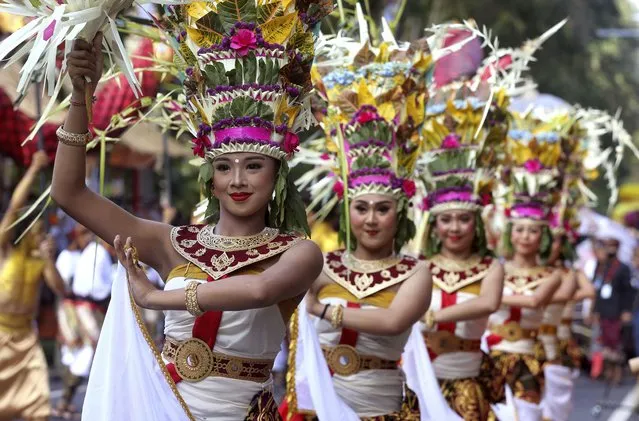 Female dancers perform during the opening of Bali Arts Festival in Bali, Indonesia, Sunday, June 12, 2022. The island of Bali is currently holding a month-long annual Bali Arts Festival from June 12 until July 10. (Photo by Firdia Lisnawati/AP Photo)