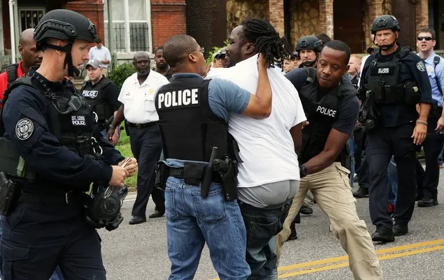 Police arrest a protester that was in the middle of the street after a shooting incident in St. Louis, Missouri August 19, 2015. (Photo by Lawrence Bryant/Reuters)