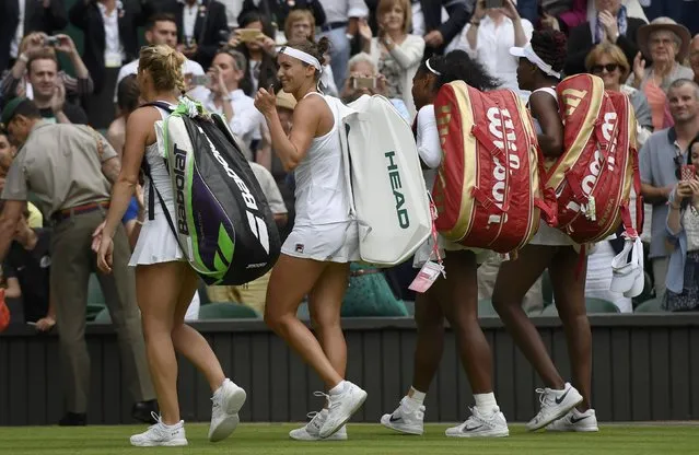 Britain Tennis, Wimbledon, All England Lawn Tennis & Croquet Club, Wimbledon, England on July 9, 2016. USA's Serena Williams and Venus Williams walk off court after winning their womens doubles final against Hungary's Timea Babos and Kazakhstan's Yaroslava Shvedova. (Photo by Tony O'Brien/Reuters)