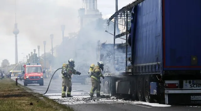 Firefighters extinguish a burning truck in Berlin, Germany, July 20, 2016. (Photo by Hannibal Hanschke/Reuters)
