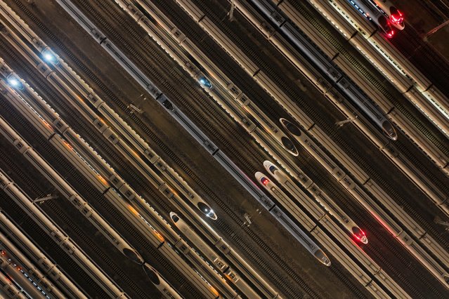 High speed trains are seen outside a maintenance workshop in Nanjing, in China's eastern Jiangsu province on December 10, 2024. (Photo by AFP Photo/China Stringer Network)