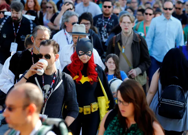 Gina Gianni of Chicago comes dressed as an animated Batgirl as she waits in a crowd to cross the street  to attend the pop culture event Comic-Con International in San Diego, California, United States July 22, 2016. (Photo by Mike Blake/Reuters)