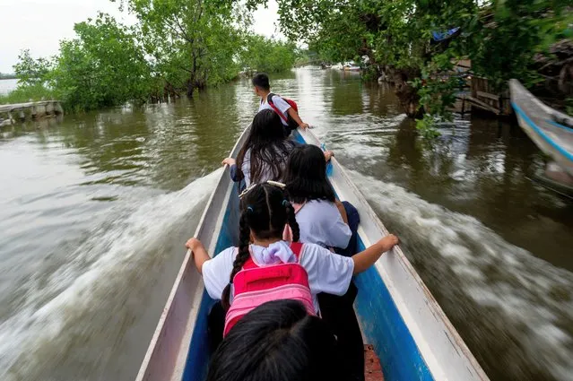 Students ride a boat on their way to school during the first day of in-person classes, in Macabebe, Pampanga province, Philippines on August 22, 2022. (Photo by Lisa Marie David/Reuters)