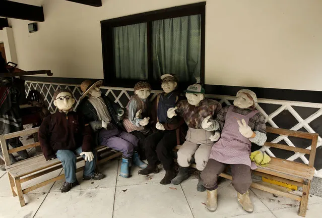 An illustration showing scarecrows resting outside of an abandoned building is on display at Kakashi no Sato, or the Scarecrow's Hometown on September 10, 2014 in Himeji, Japan. (Photo by Buddhika Weerasinghe/Getty Images)