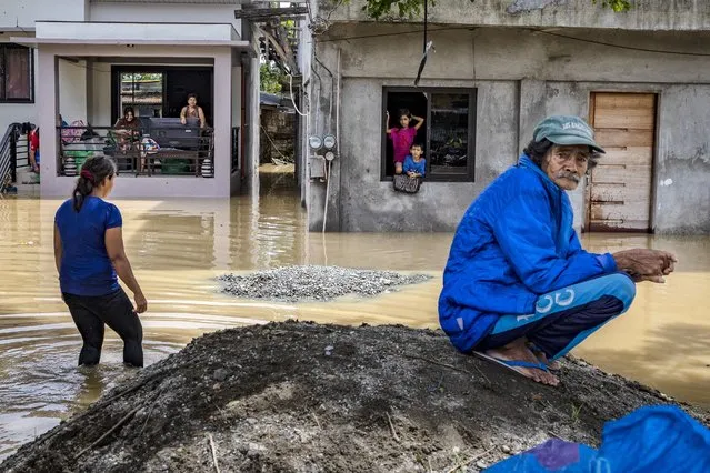 Residents stay inside their homes flooded by Super Typhoon Noru on September 26, 2022 in San Ildefonso, Bulacan province, Philippines. (Photo by Ezra Acayan/Getty Images)