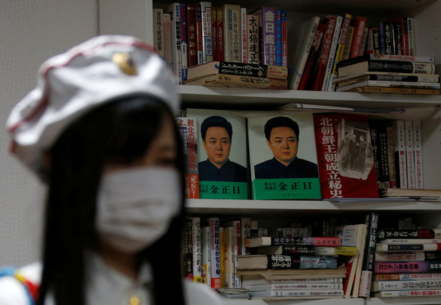 A member of Japan's North Korea fan club called sengun-joshi, or military-first girls, is seen in front of books of North Korea during their Moranbong Band dance practice in Tokyo, Japan on November 2, 2017. (Photo by Toru Hanai/Reuters)