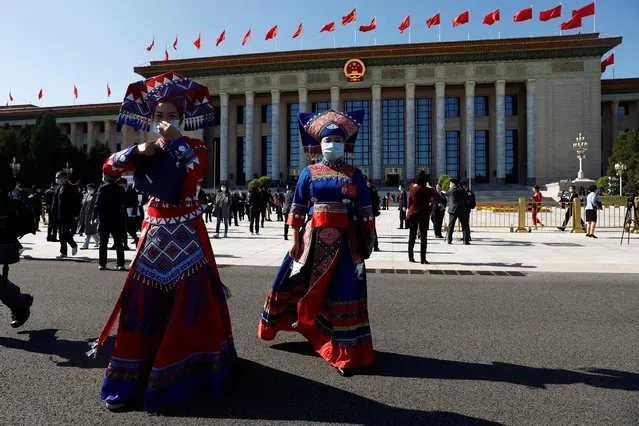 Delegates in ethnic minority costumes leave the Great Hall of the People after the opening ceremony of the 20th National Congress of the Communist Party of China in Beijing, China on October 16, 2022. (Photo by Thomas Peter/Reuters)